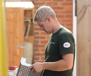 An iHeat solar installer preparing a mounting bracket
