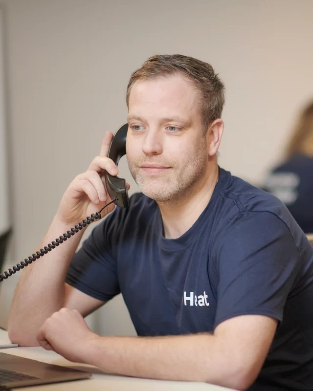 An iHeat team member speaking with a customer on the phone