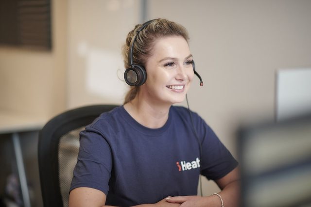 An iHeat customer support adviser wearing a headset